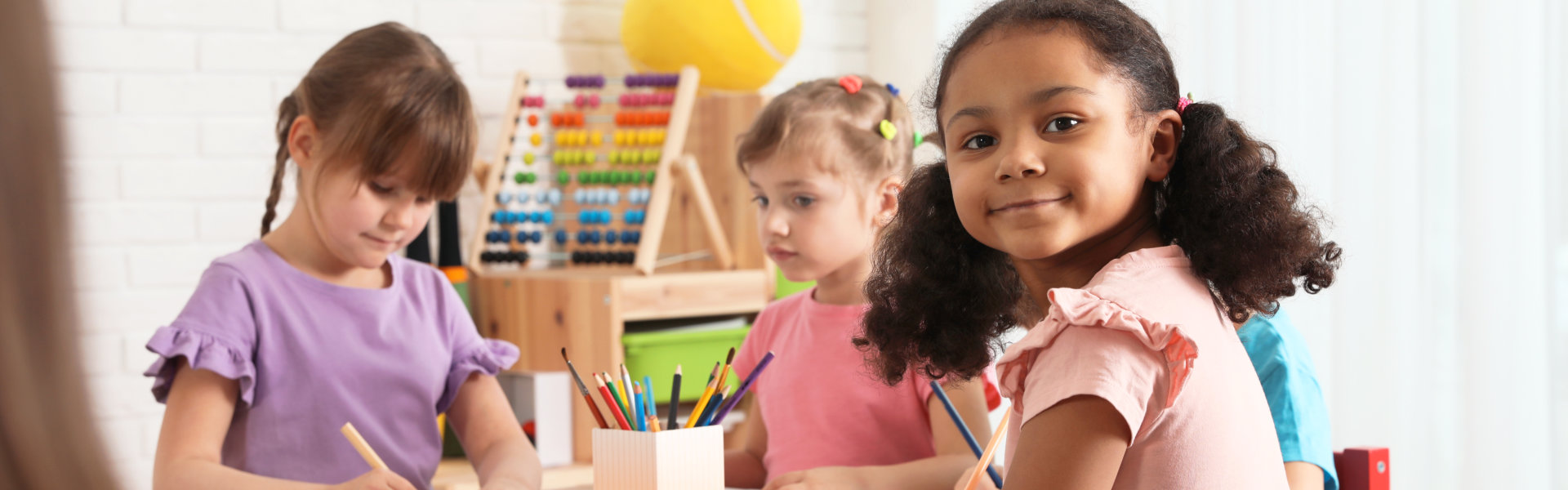 Adorable children drawing together at table indoors