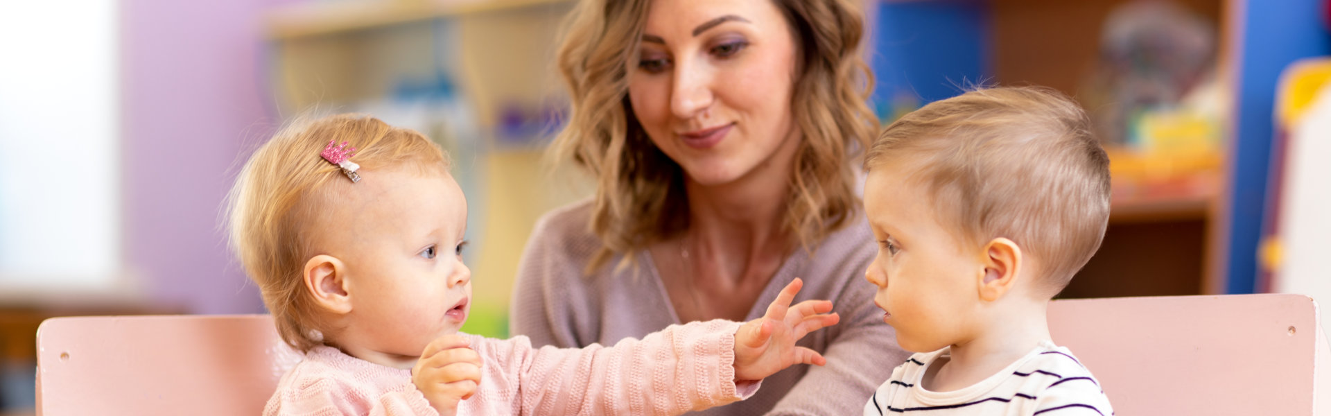 Babies with mentor in kindergarten
