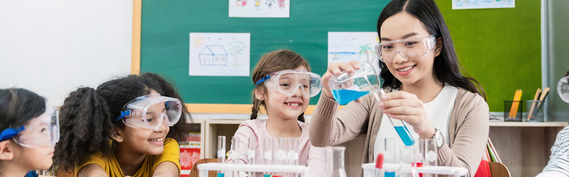 Portrait of happy kids at elementary school learning science chemistry